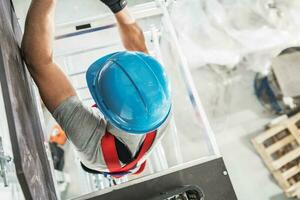 Construction Worker Climbing on Scaffolding photo