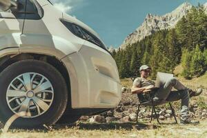 Men Working Remotely While Camping in Motorhome photo