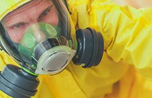 Tired Caucasian Worker in Hazmat Suit and Face Mask photo