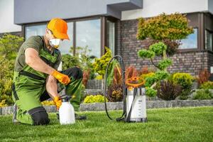 Landscaper Preparing to Perform Pest Control Treatment photo