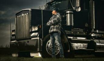 American Transportation Industry Theme with Trucker and His Semi Truck photo