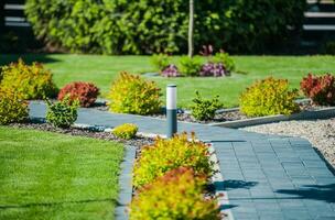 Modern Garden with Brick Path and Outdoor Lighting photo