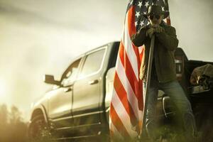 American Patriot Cowboy Farmer Staying  in Front of His Pickup Truck photo