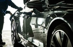 Detailing Worker Preparing Car Body For Waxing photo