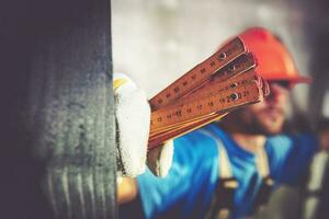 Worker with Measuring Tool photo