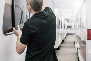 RV Travel Trailers Specialist Performing Windows Seals Check photo