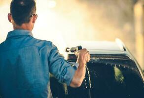 Spring Time Car Washing Using Pressure Washer photo