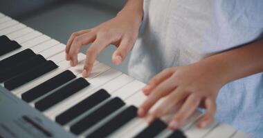 Cute boy enjoy to learning playing piano at home photo