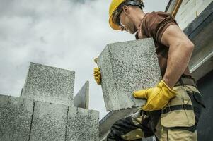 Hollow Dense Concrete Blocks Moved by Construction Worker photo