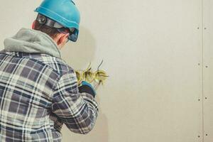 Electric Contractor Sets Wires For Plug Installation. photo