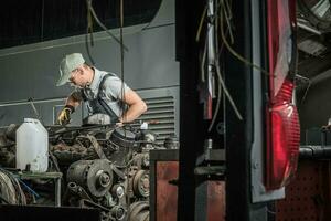 Automotive Technician Restoring Old Diesel Engine photo