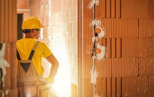 Construction Worker Inside Newly Built Concrete Blocks Building photo