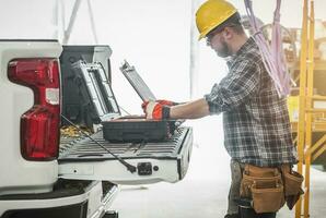 Construction Worker Reading HVAC Assembly Plan and Documentation on a Site photo