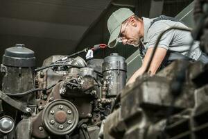 Automotive Technician Restoring Truck Engine photo