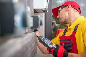 Technician with Gas Leak Detector Performing Scheduled Check photo