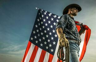 Cowboy with American Flag and a Rope in His Hands photo