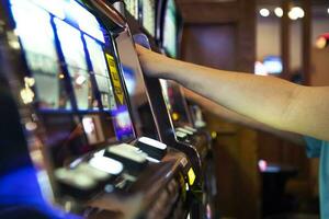 People Playing Casino Slot Machines Close Up photo