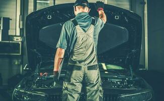 Satisfied Mechanic Closing the Vehicle Bonnet photo