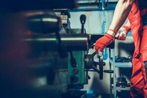 Caucasian Lathe Machine Technician During Metal Boring Process photo