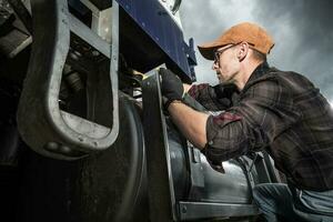 Semi Truck Driver Checking Vehicle Elements photo