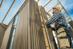 Caucasian General Construction Worker Building Small Modern Garden Shed photo