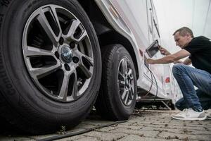 Mechanic man working on automobile photo