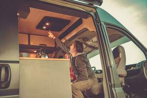 Men Turning Off Camper Van Air Condition Unit photo