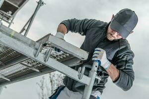 Worker Installing Scaffolding photo