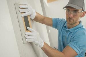 Home Finishing Worker Applying Modern Vinyl Wallpaper. photo