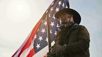 Proud American Cowboy Staying Next to National Flag video