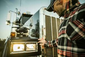 Professional Driver Checking On His Semi Truck Headlights photo