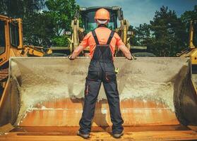 Heavy Equipment Operator Hooks Up Specialized Bucket To Machine. photo