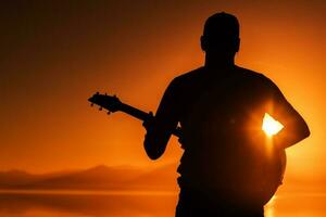 guitarra jugando a puesta de sol foto