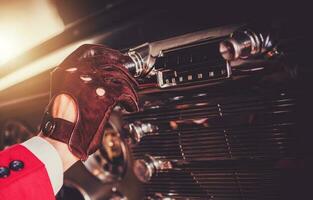 Driver Changing Radio Station In His Classic Car photo