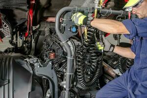 Semi Truck Mechanic Doing His Job photo