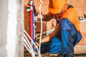 Plumber Installing Bathroom Water Supply photo