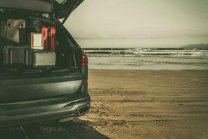 Car Full of Luggages on a Beach Summer Vacation Getaway Concept photo