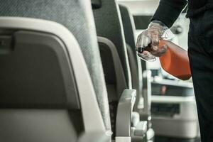 Bus Coach Interior Disinfection by Caucasian Worker photo