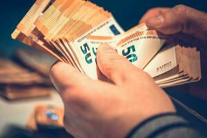 Counting Euro Banknotes in Hands photo