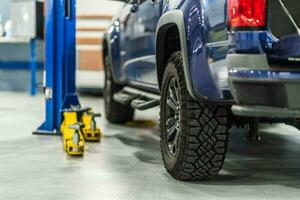 Auto Service and Broken Car on an Automotive Lift photo