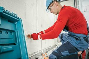 Professional Electrician Contractor Installing Electric Socket photo