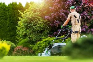 Residential Garden Worker Trimming Backyard Lawn photo