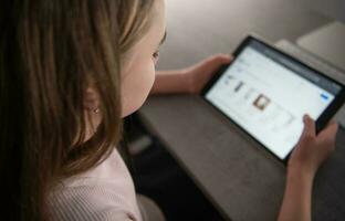 Caucasian Girl with Tablet Device in Her Hands photo