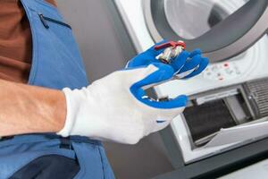 Plumber Installing Additional Water Supply Outlet For a Washing Machine photo