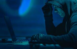 Hacker in Front of His Laptop Computer photo