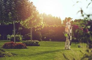 Caucasian Pro Gardener in His Clients Backyard Garden photo