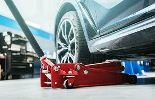 Modern Vehicle and the Floor Jack Lift Vehicle Maintenance photo