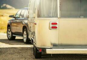 SUV with Retro Classic Travel Trailer Road Trip photo