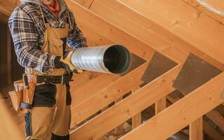 HVAC Worker with Piece of Air Duct Pipeline in His Hands photo
