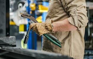 Automotive Industry Worker with Car Repairing Tools in His Hands photo